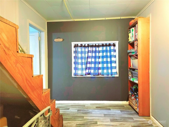 interior space with crown molding and light hardwood / wood-style floors