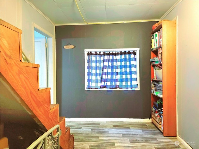interior space featuring crown molding and wood finished floors