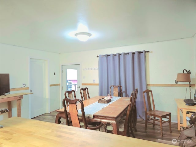 dining space featuring wood-type flooring