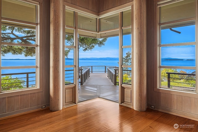 doorway to outside featuring a water view and wood-type flooring