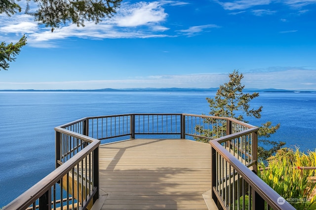 view of dock with a water and mountain view