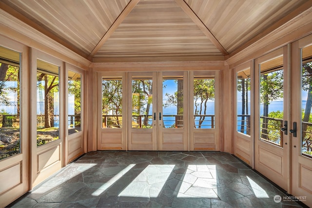 unfurnished sunroom featuring a water view, vaulted ceiling, french doors, and wooden ceiling