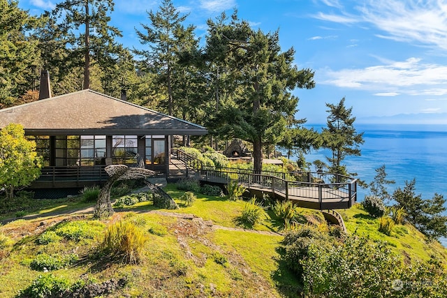 view of yard featuring a deck with water view