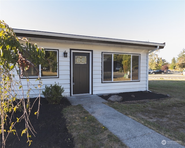 doorway to property with a yard