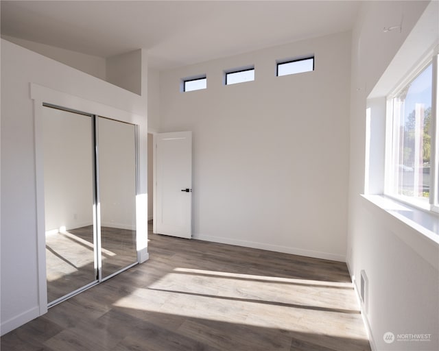 unfurnished bedroom with a closet and hardwood / wood-style floors