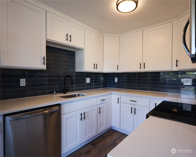 kitchen featuring decorative backsplash, dark hardwood / wood-style flooring, sink, stainless steel appliances, and white cabinetry