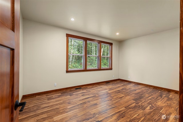 spare room with hardwood / wood-style flooring