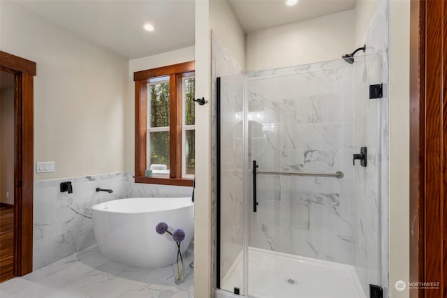 bathroom with independent shower and bath and tile walls