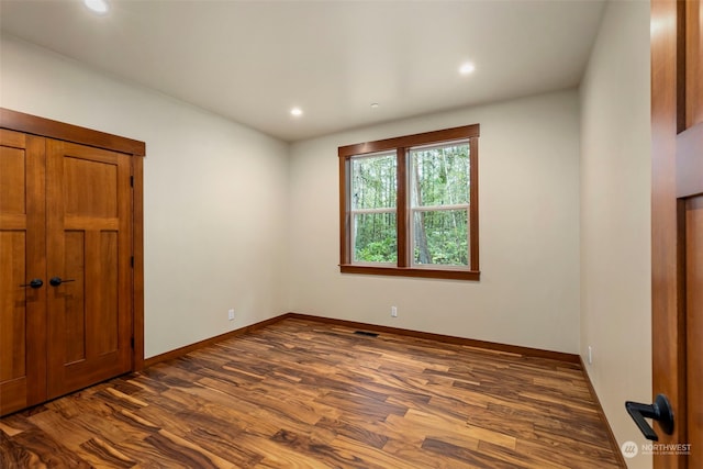 spare room featuring dark hardwood / wood-style flooring