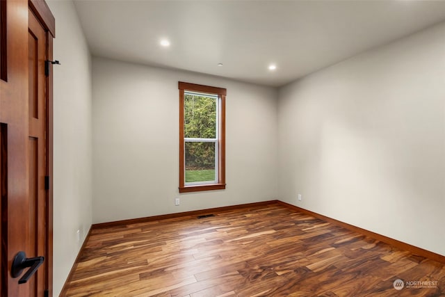 spare room featuring dark hardwood / wood-style floors