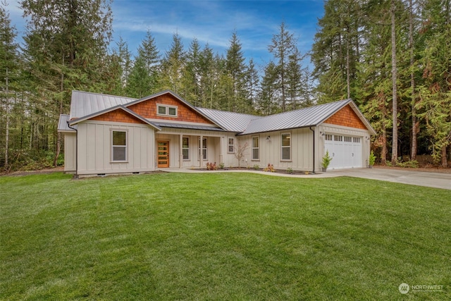 view of front of home featuring a front lawn, covered porch, and a garage