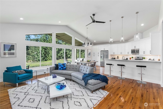 living area featuring ceiling fan, recessed lighting, wood finished floors, and high vaulted ceiling