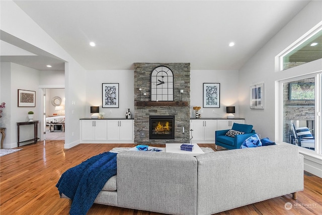 1690 Lilypad Pl E, Port Orchard, WA 98366 - living area with vaulted ceiling, a fireplace, light wood finished floors, recessed lighting, and baseboards