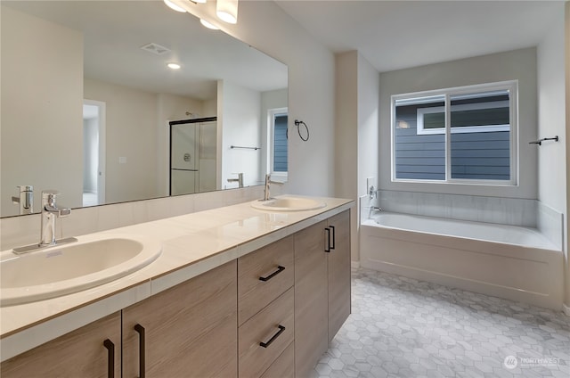 bathroom with tile patterned floors, vanity, and plus walk in shower