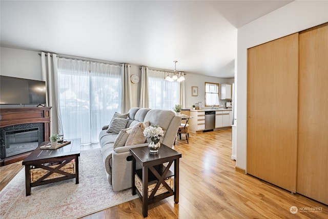 living room featuring an inviting chandelier and light hardwood / wood-style flooring