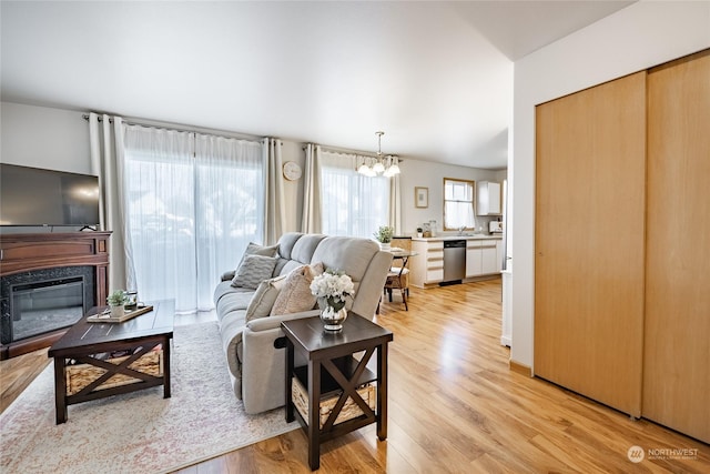 4232 Wintergreen Cir Unit 160, Bellingham, WA 98226 - living room with a chandelier, light wood-style floors, and a high end fireplace