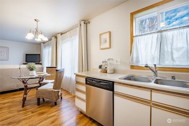 kitchen featuring sink, an inviting chandelier, white cabinetry, decorative light fixtures, and stainless steel dishwasher