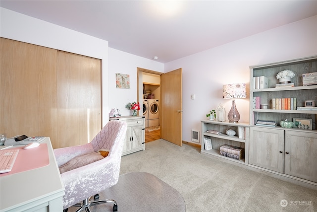 office space featuring light carpet and washer and dryer