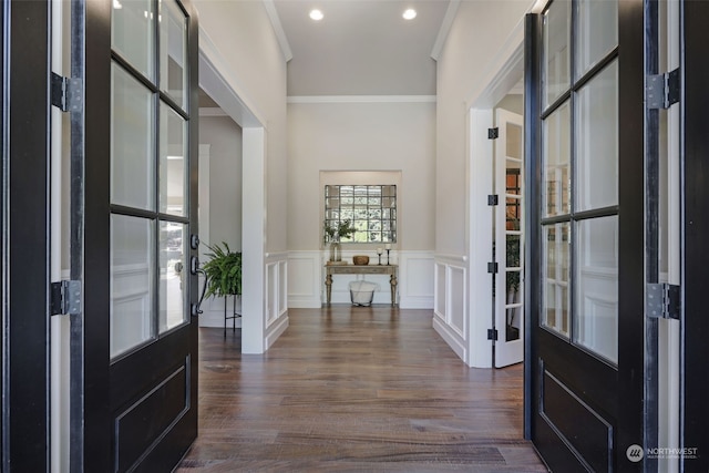 foyer featuring french doors, dark hardwood / wood-style flooring, and ornamental molding