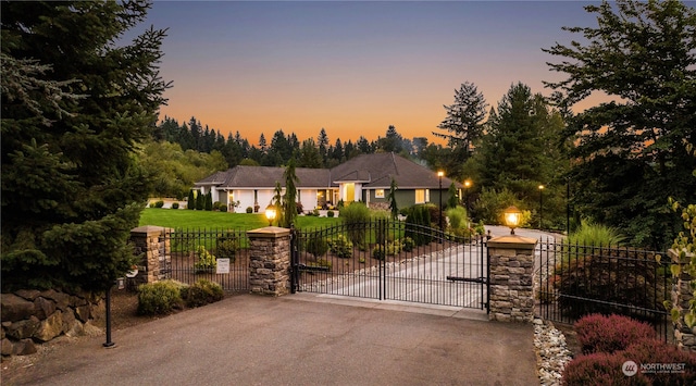 view of front of house featuring a garage and a lawn