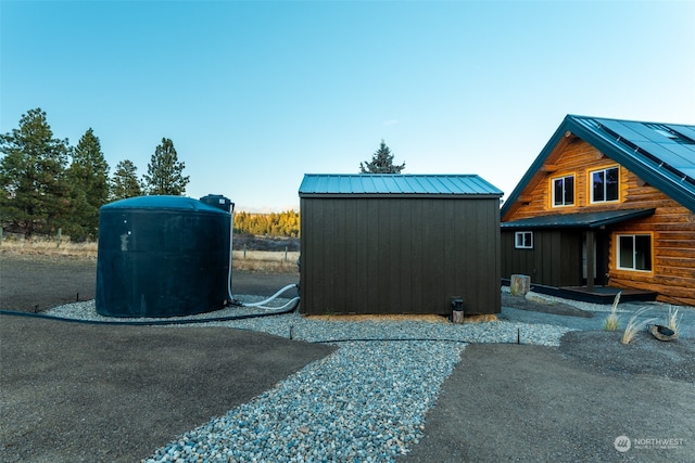 view of side of property featuring a shed