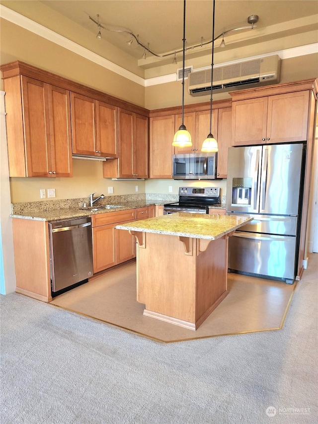 714 Market St Unit 303, Tacoma, WA 98402 - kitchen featuring light stone countertops, a kitchen breakfast bar, a center island, hanging light fixtures, and stainless steel appliances
