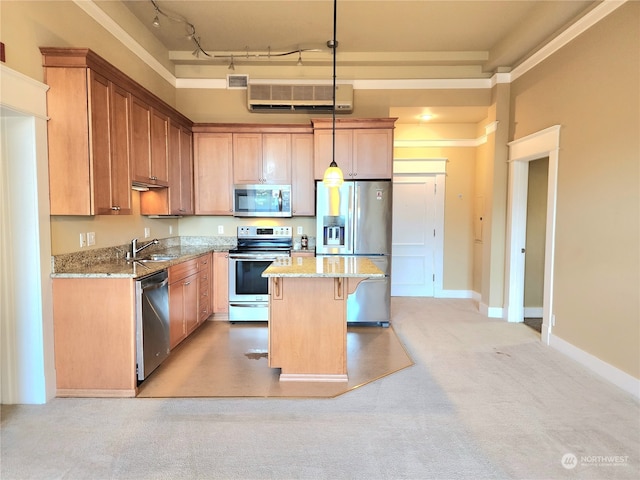 kitchen featuring pendant lighting, light stone countertops, a center island, and stainless steel appliances