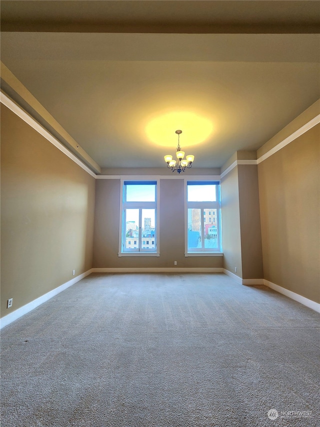 empty room with a chandelier and carpet flooring