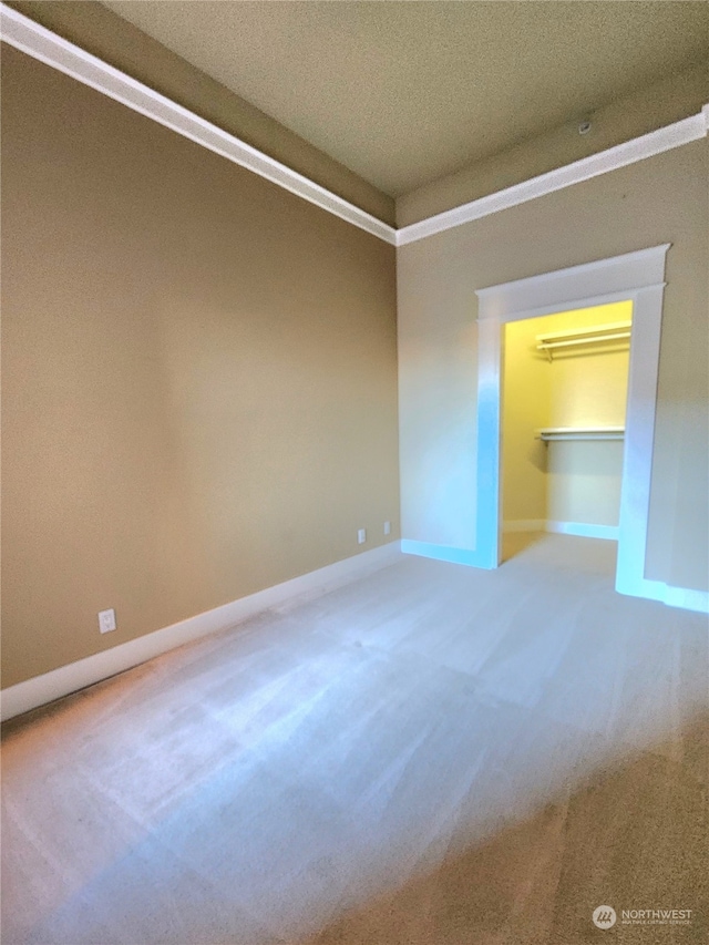 carpeted spare room featuring a textured ceiling