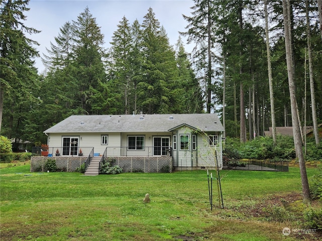 back of house featuring a yard and a deck