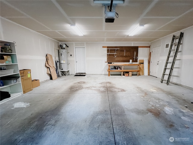 garage with water heater, a garage door opener, and a workshop area