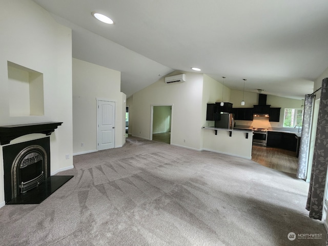 unfurnished living room featuring a wall unit AC, carpet floors, and vaulted ceiling