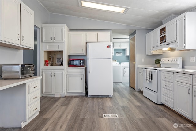 kitchen featuring white appliances, vaulted ceiling, white cabinetry, washing machine and dryer, and light hardwood / wood-style floors