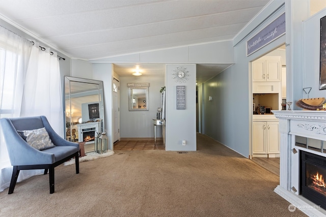 living area featuring vaulted ceiling and light carpet