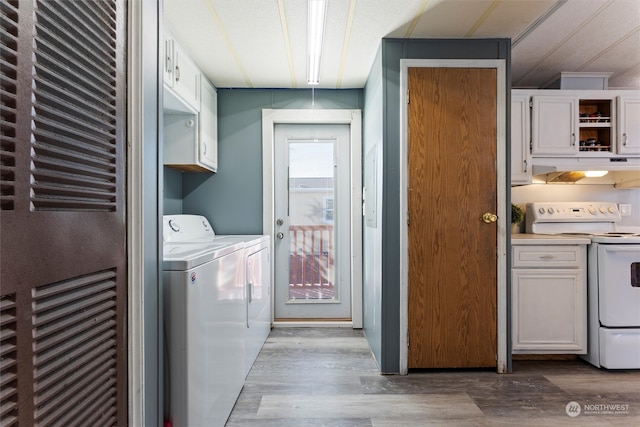 laundry area featuring light wood-type flooring and washing machine and clothes dryer