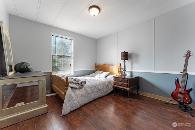 bedroom featuring dark hardwood / wood-style floors and a textured ceiling