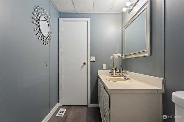 bathroom featuring vanity, hardwood / wood-style floors, and toilet