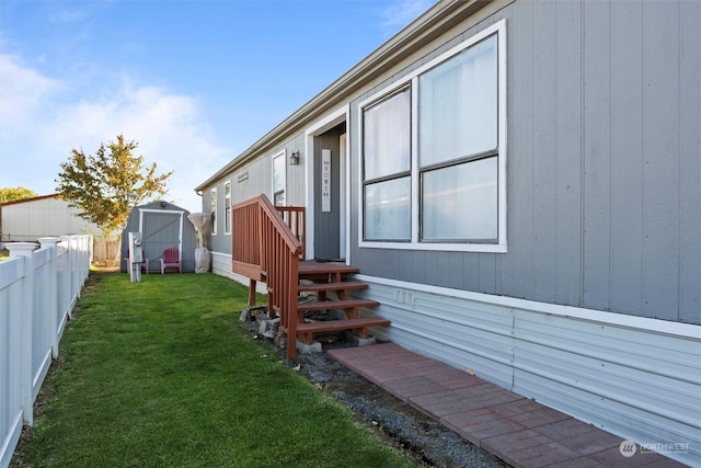 view of side of property featuring a shed and a yard