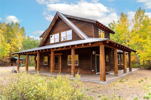 rear view of house featuring covered porch