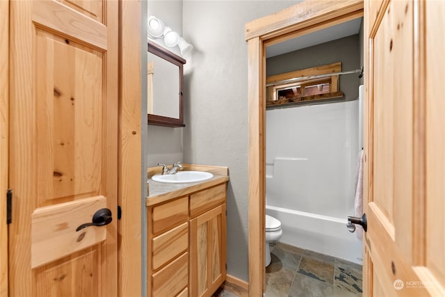 full bathroom with tub / shower combination, vanity, and toilet