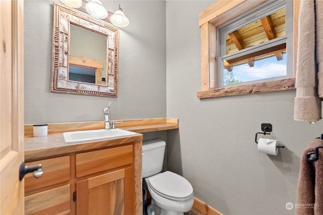 bathroom featuring vanity, wood ceiling, and toilet