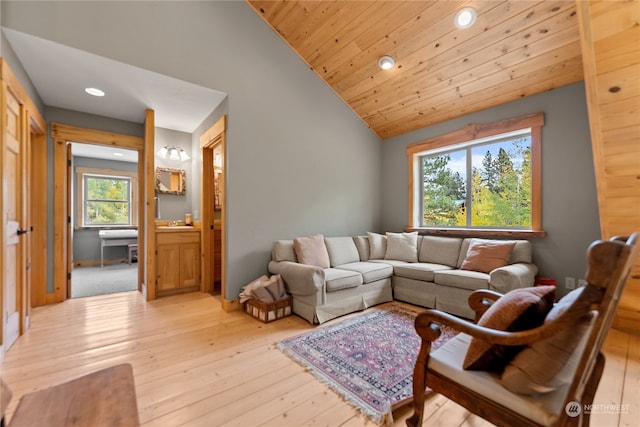 living room featuring lofted ceiling, light wood-type flooring, and wooden ceiling