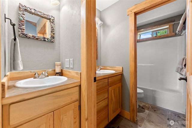 bathroom featuring vanity and toilet