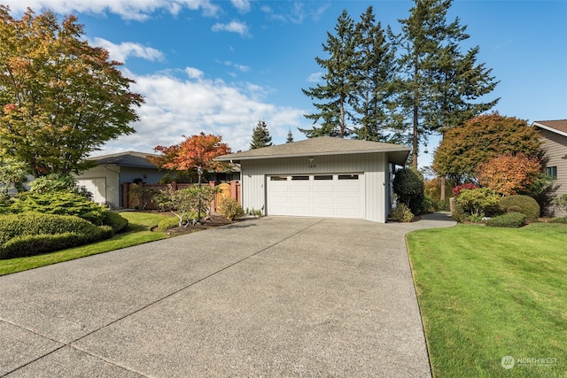 view of front of property featuring a front lawn and a garage