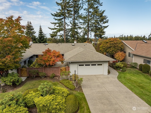 view of front of property with a garage and a front yard