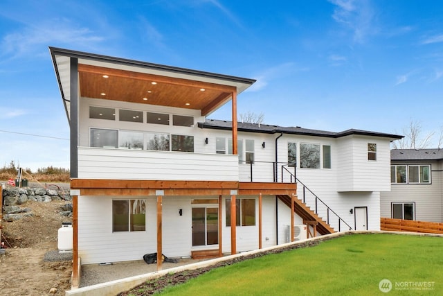 8721 Semiahmoo Dr, Blaine, WA 98230 - rear view of house with a deck, a yard, and stairway