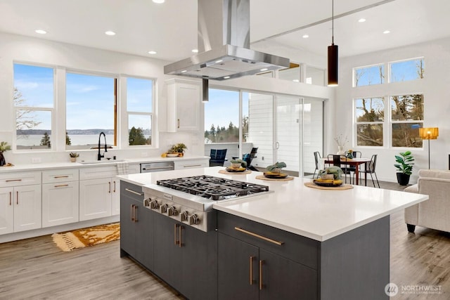 8721 Semiahmoo Dr, Blaine, WA 98230 - kitchen with white cabinets, appliances with stainless steel finishes, a sink, and island range hood