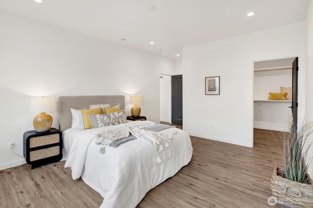 8721 Semiahmoo Dr, Blaine, WA 98230 - bedroom featuring light wood-type flooring, recessed lighting, baseboards, and a walk in closet