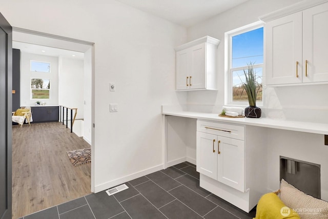 8721 Semiahmoo Dr, Blaine, WA 98230 - laundry room featuring cabinet space, baseboards, dark tile patterned flooring, hookup for an electric dryer, and visible vents