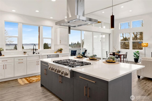 8721 Semiahmoo Dr, Blaine, WA 98230 - kitchen featuring white cabinets, appliances with stainless steel finishes, a sink, and island range hood